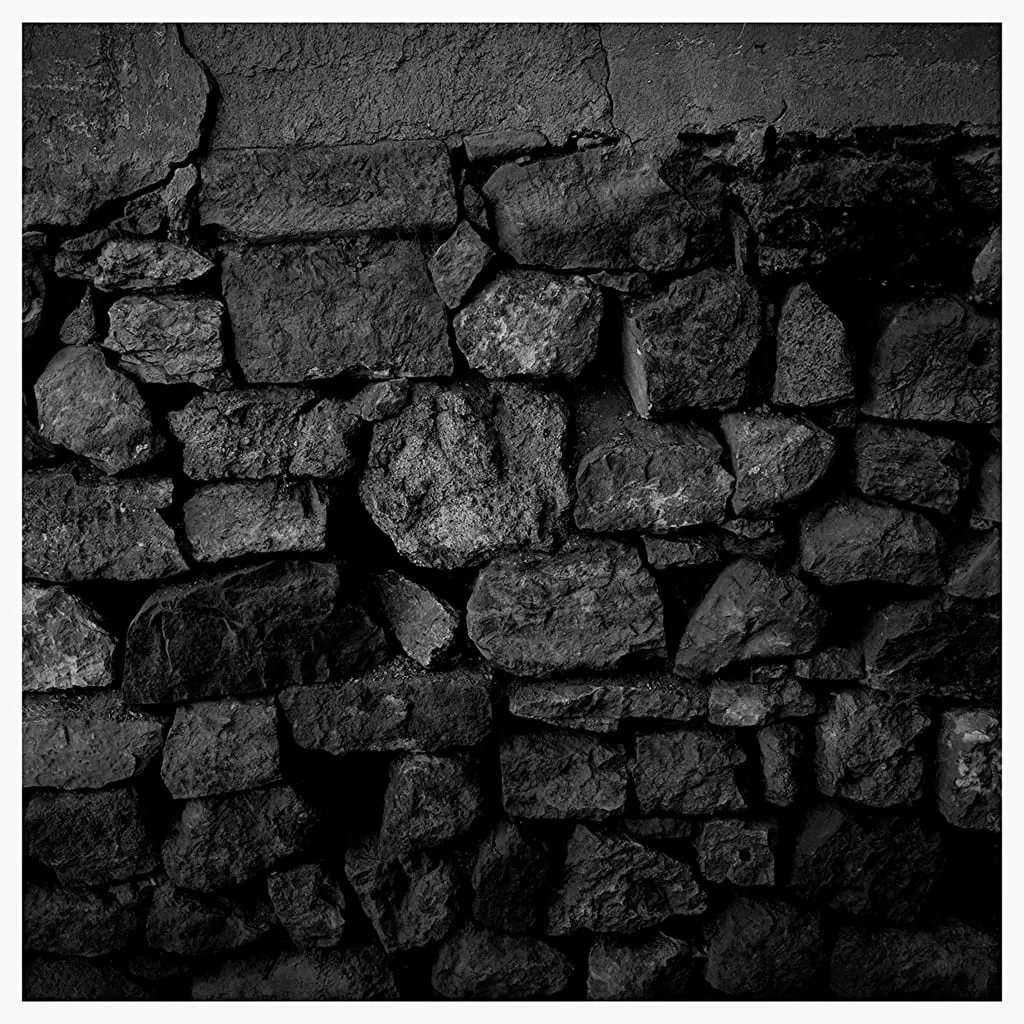 A rugged dry-stacked stone wall detail.